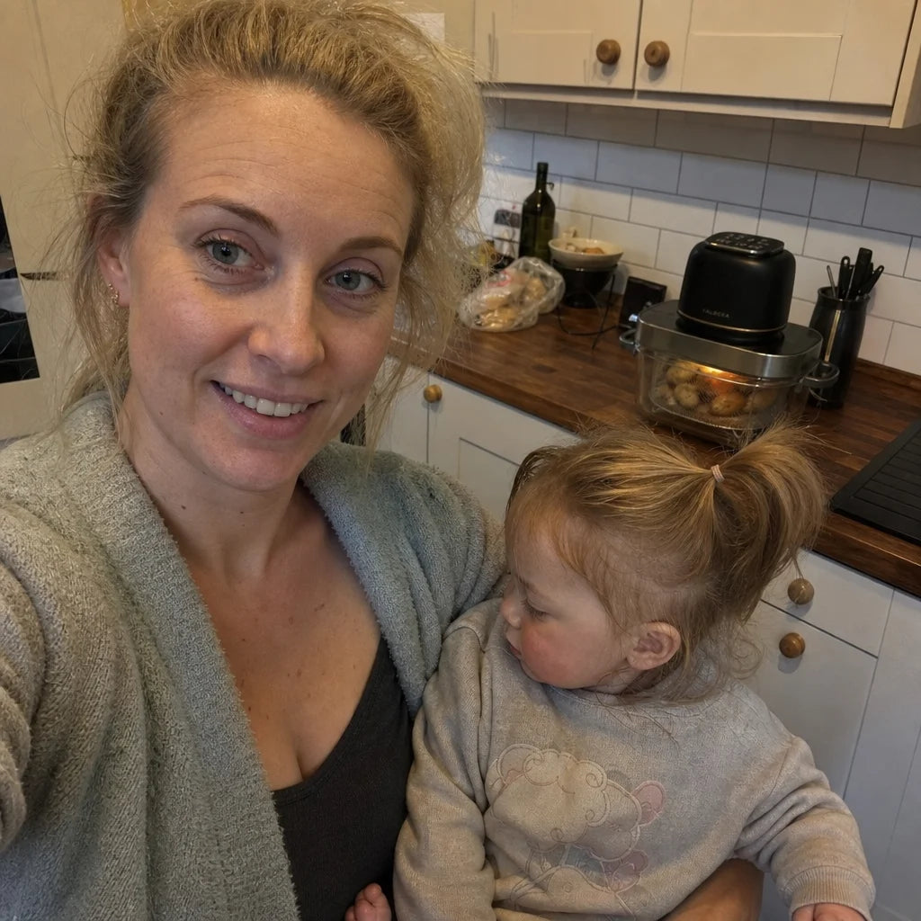 Fiona with her toddler in the kitchen, the Kaldera Glass behind them